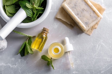 Photo of Composition with mint essential oil on light background
