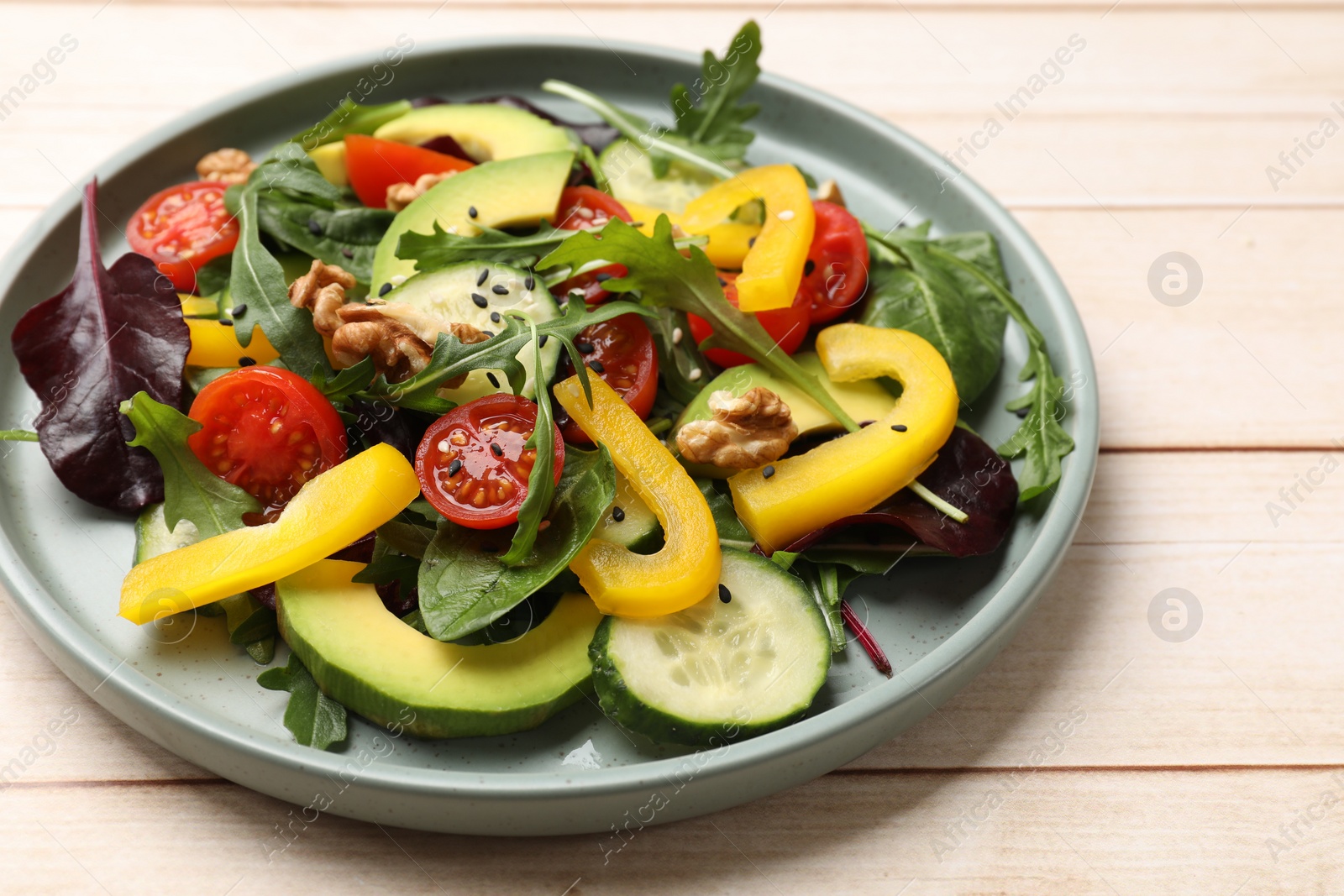 Photo of Balanced diet and vegetarian foods. Plate with different delicious products on wooden table, closeup