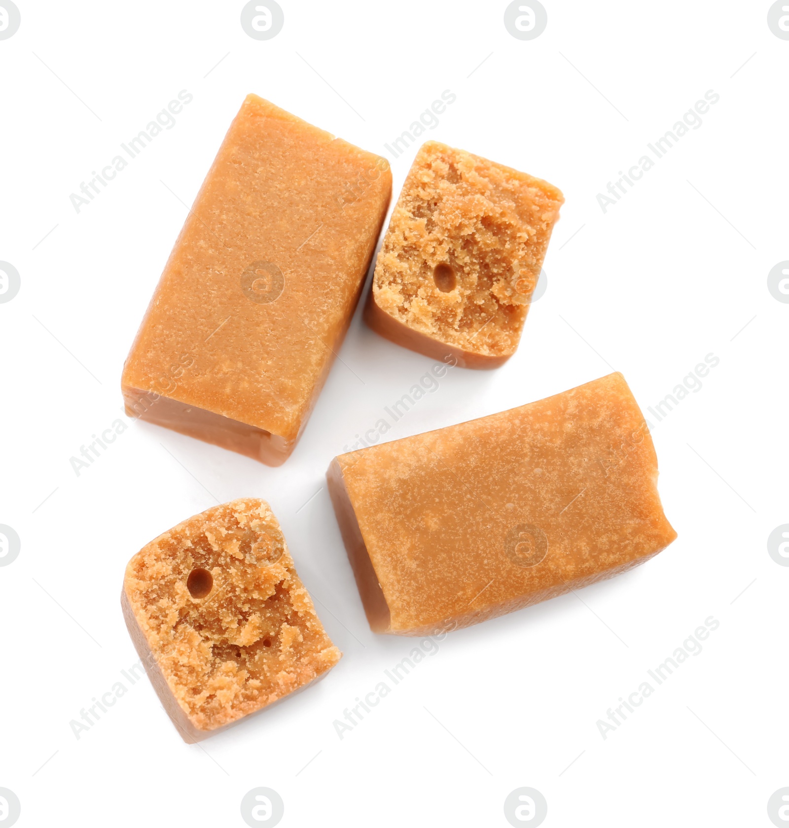 Photo of Delicious caramel candies on white background