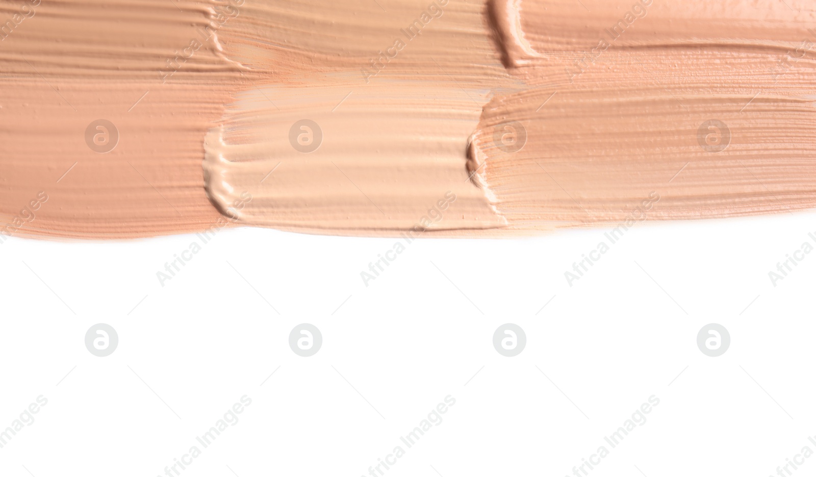 Photo of Samples of different foundation shades on white background, top view