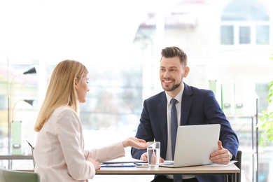 Young consultant working with client in office