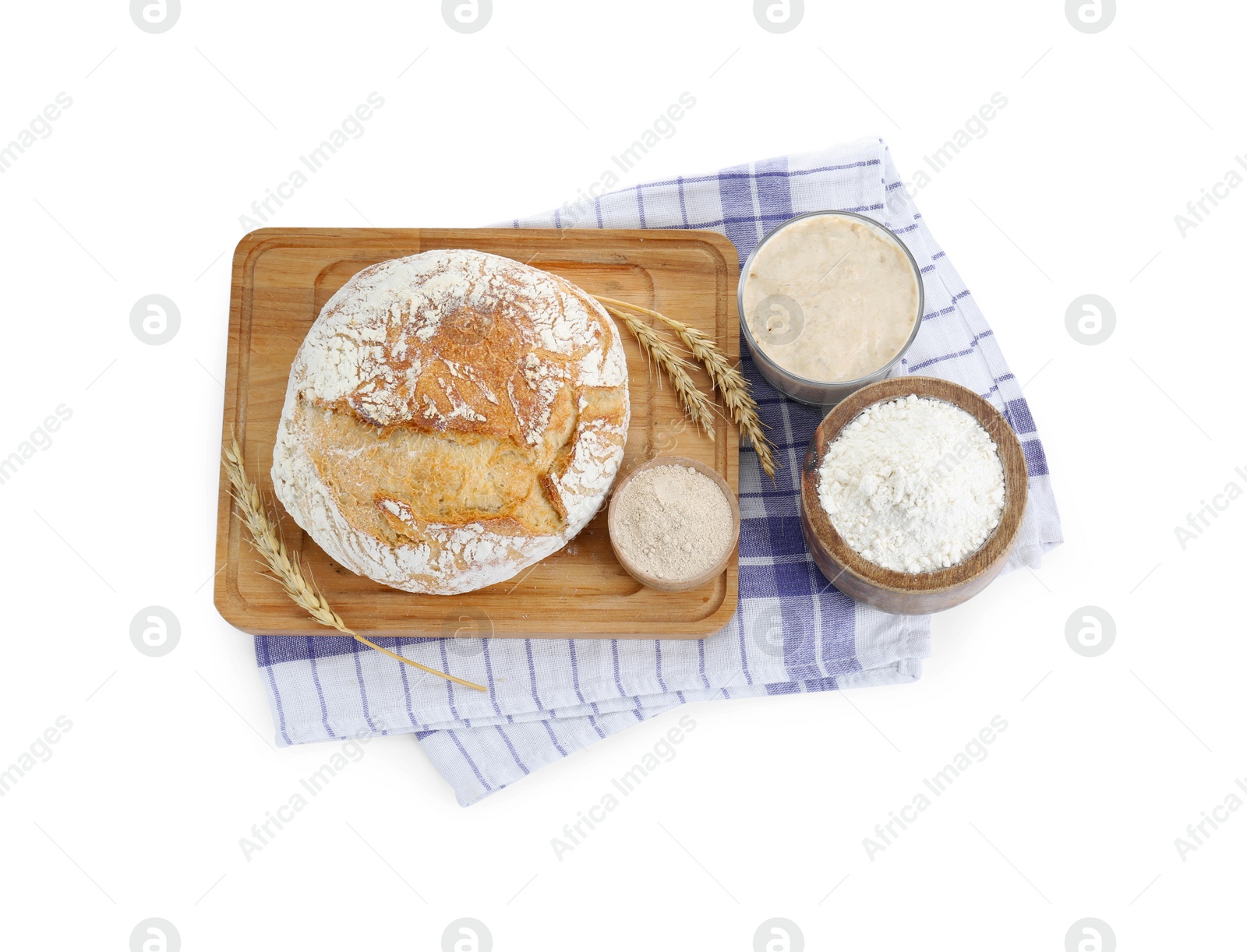 Photo of Freshly baked bread, sourdough, flour and spikes on white background, top view