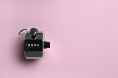 Modern timer on pink background, top view. Space for text