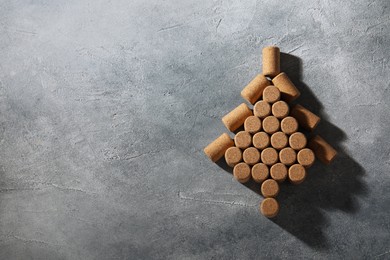 Christmas tree made of wine corks on grey table, top view. Space for text