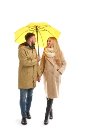 Full length portrait of beautiful couple with umbrella, isolated on white