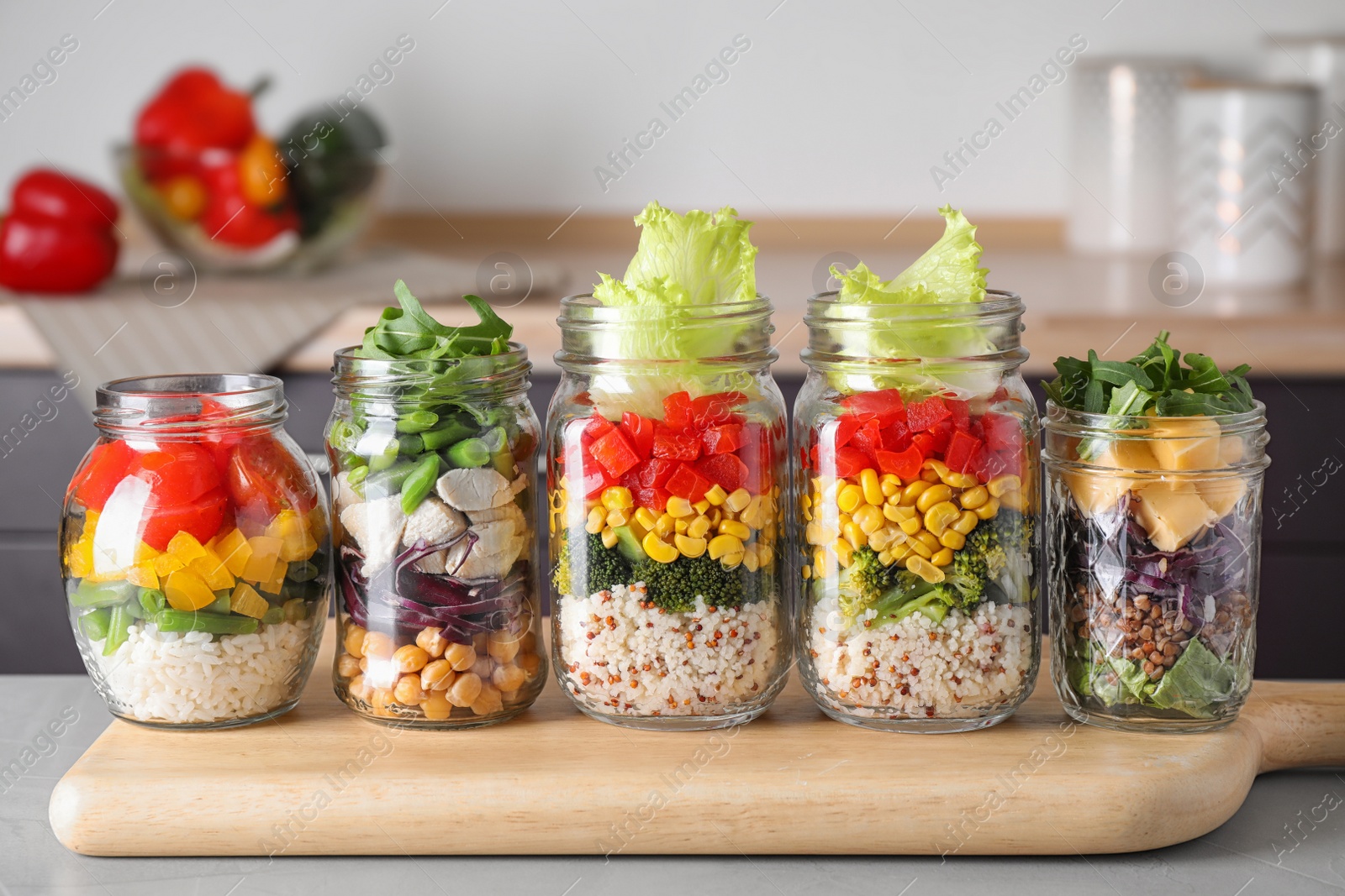 Photo of Glass jars with healthy meal on light grey table