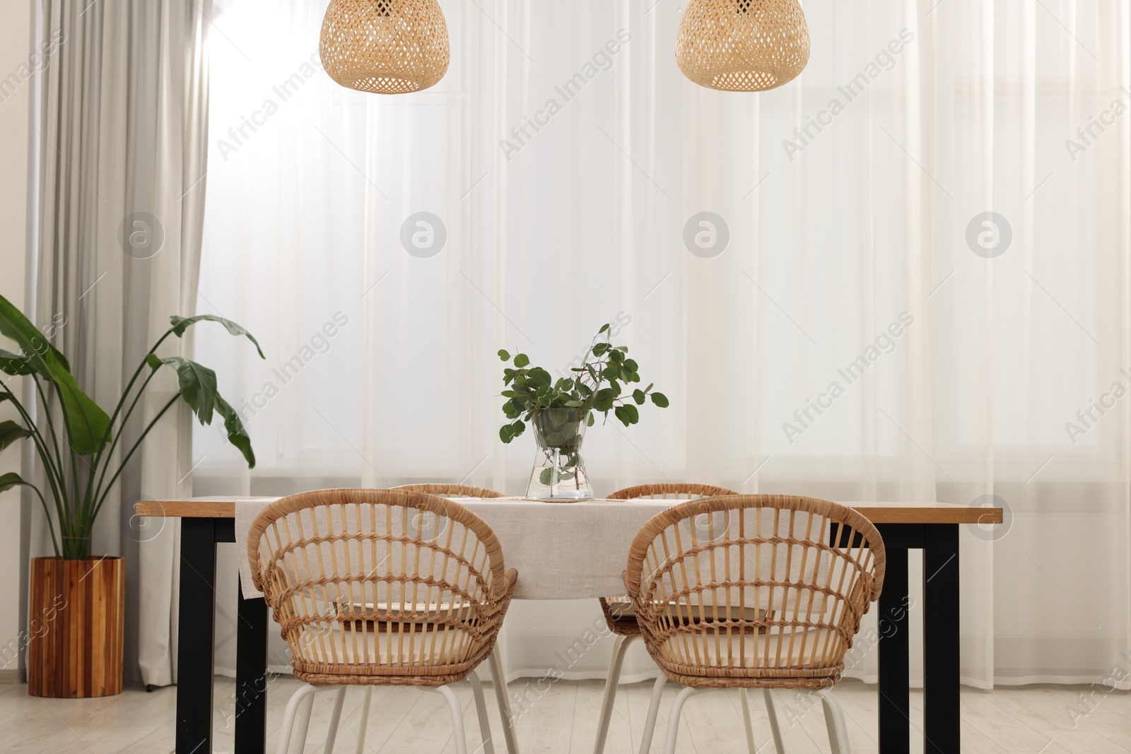 Photo of Stylish dining room with cozy furniture and plants