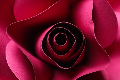 Photo of Beautiful red flower made of paper as background, top view