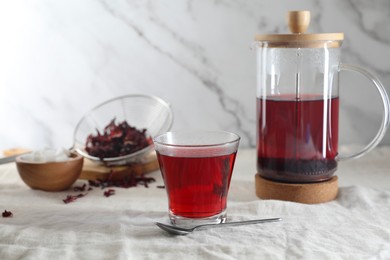 Photo of Delicious hibiscus tea and spoon on table