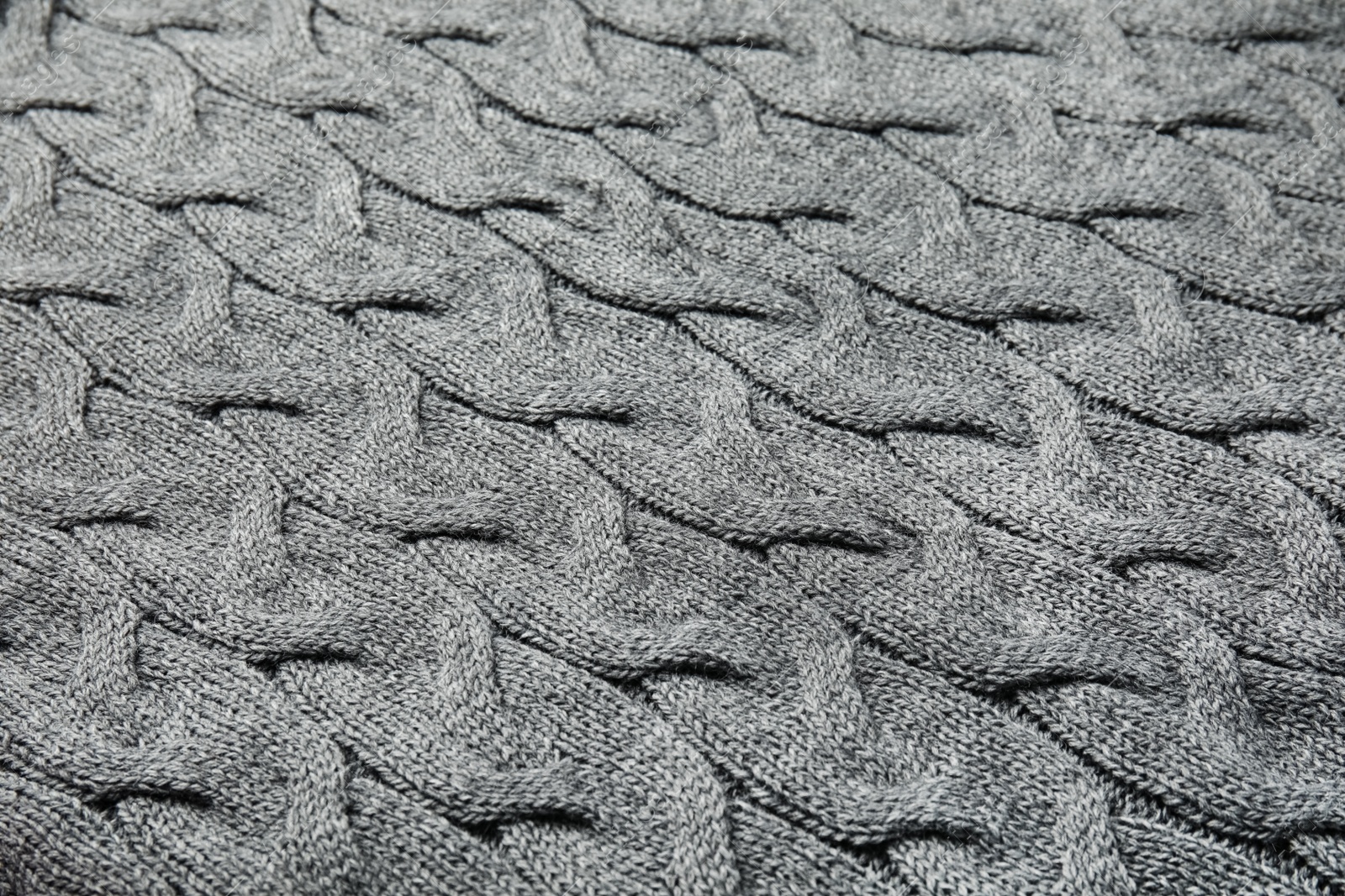 Photo of Soft grey knitted plaid as background, closeup