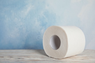 Photo of Toilet paper roll on table. Space for text