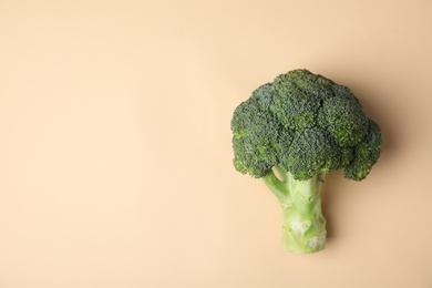 Photo of Fresh green broccoli on color background, top view. Space for text