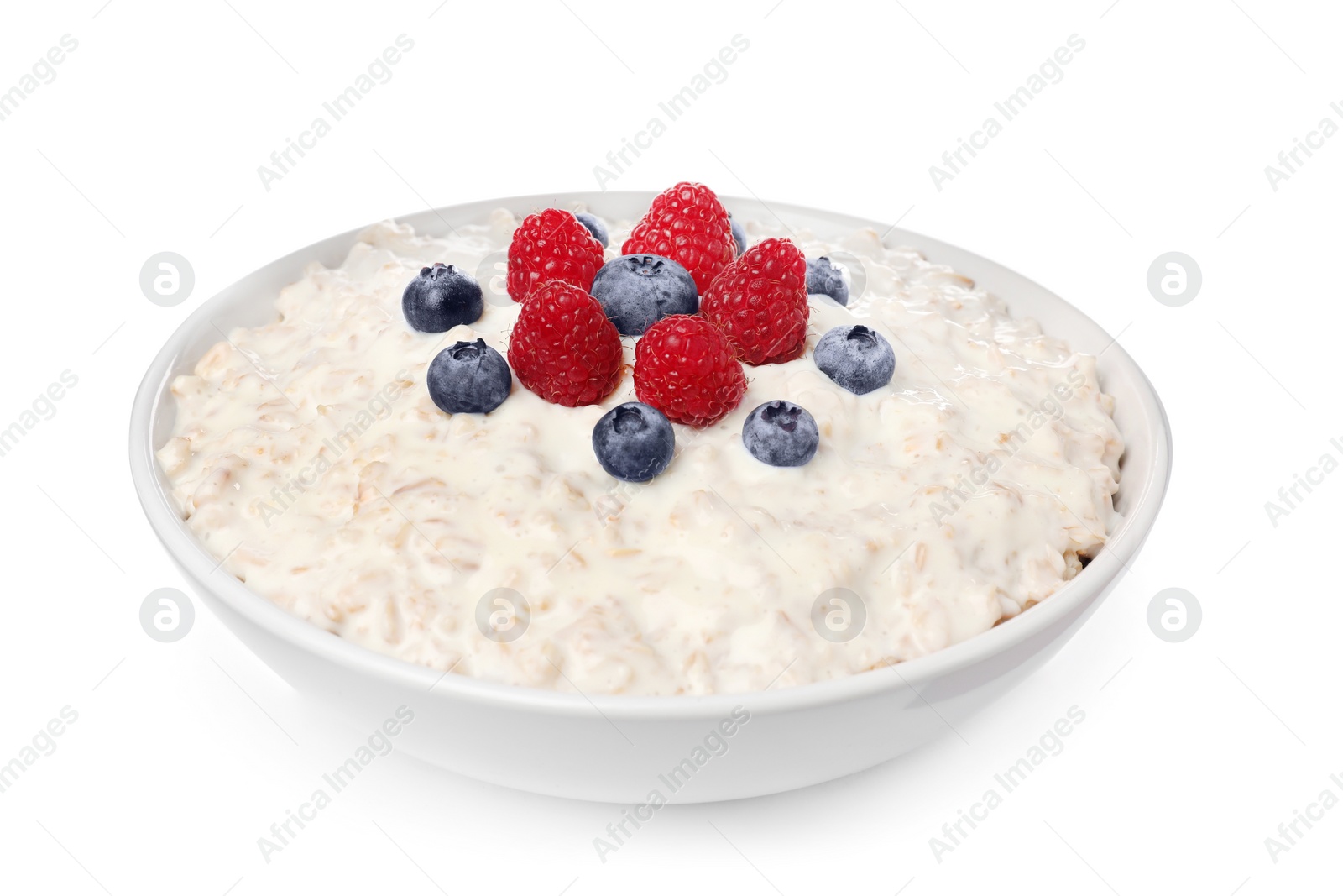 Photo of Tasty boiled oatmeal with berries in bowl isolated on white