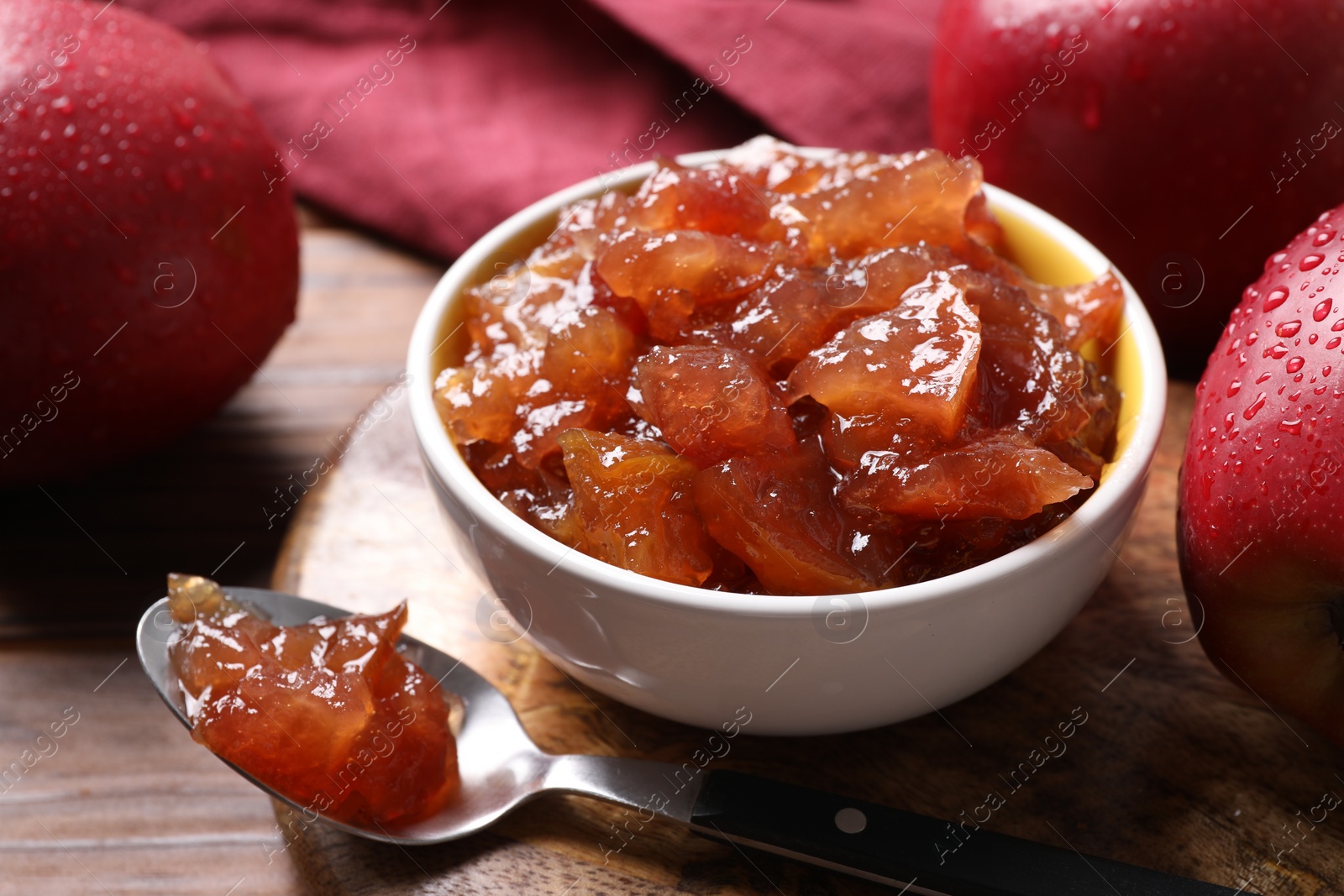 Photo of Delicious apple jam and fresh fruits on wooden table, closeup