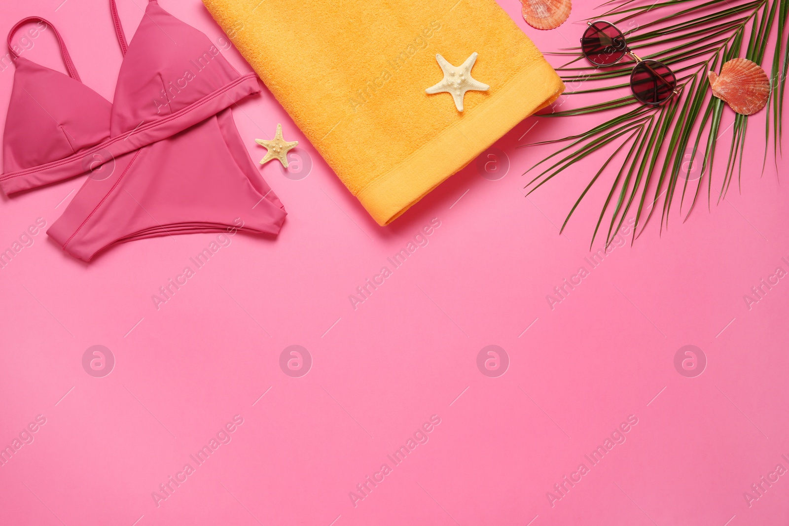 Photo of Flat lay composition with different beach objects on pink background, space for text