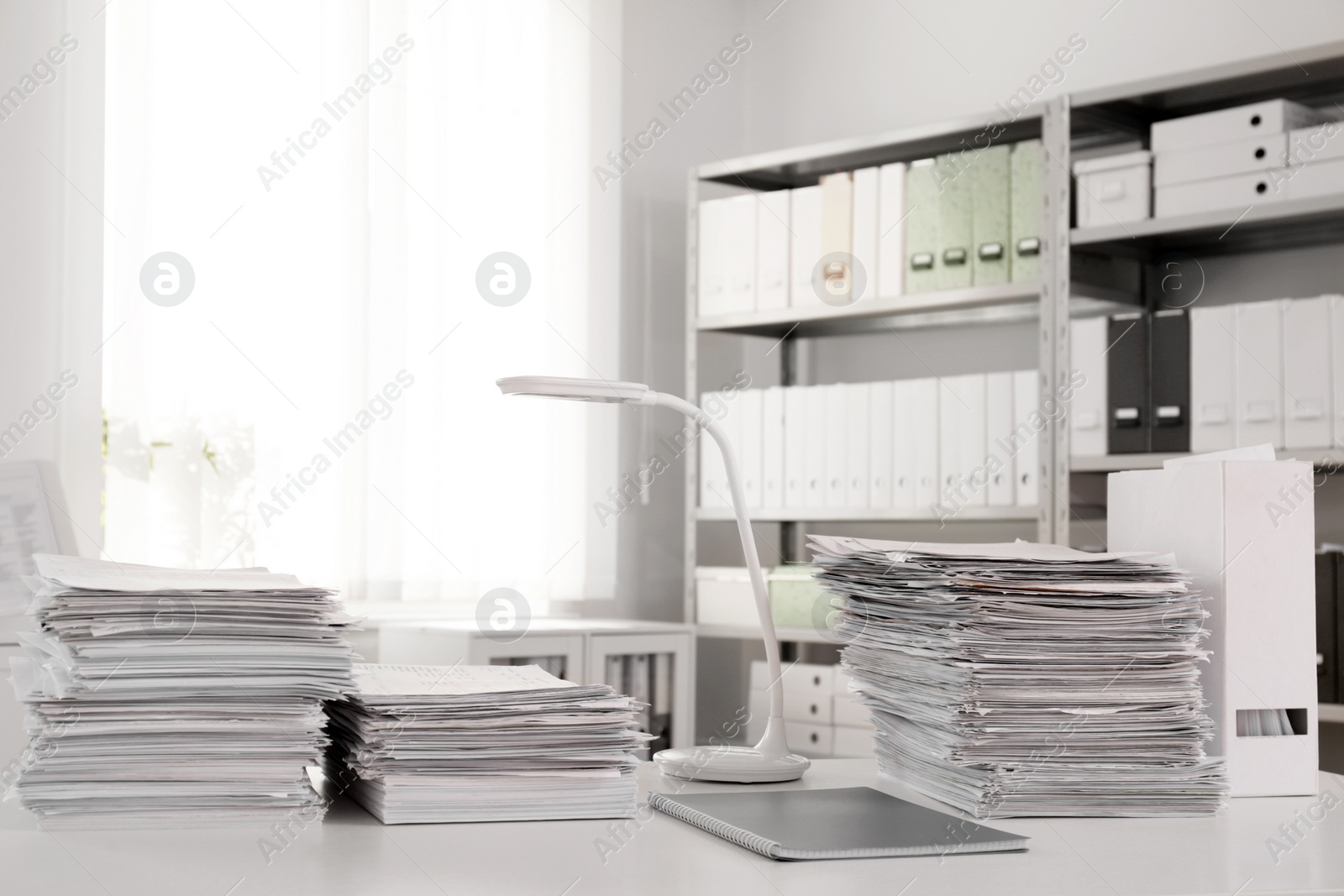 Photo of Stacks of documents on table in office