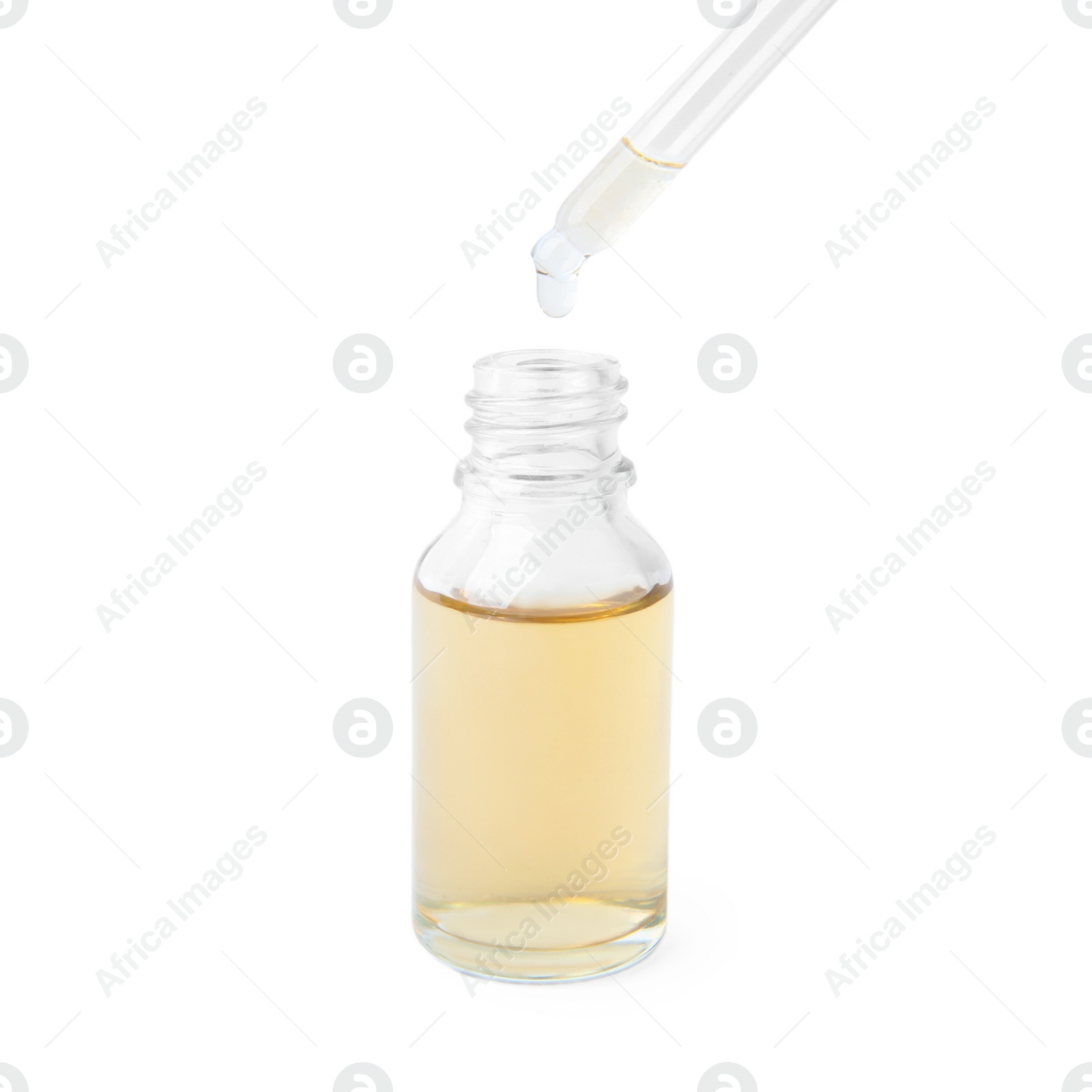 Photo of Dripping essential oil from pipette into glass bottle on white background