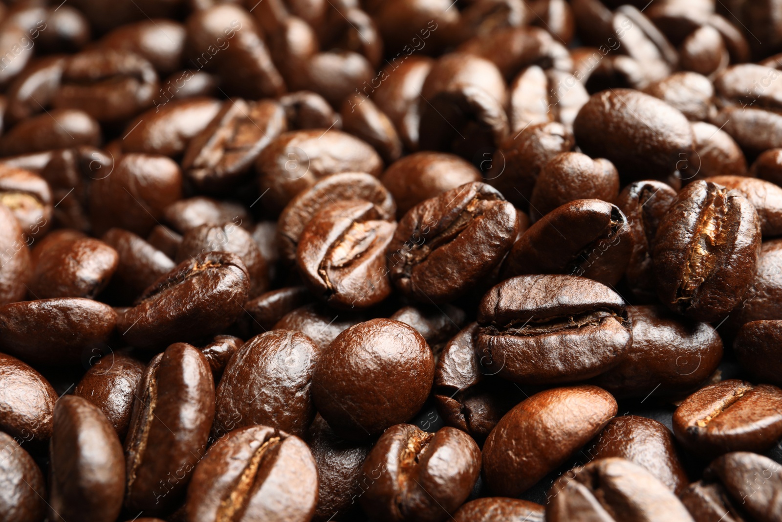 Photo of Pile of roasted coffee beans as background, closeup