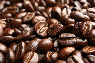 Pile of roasted coffee beans as background, closeup