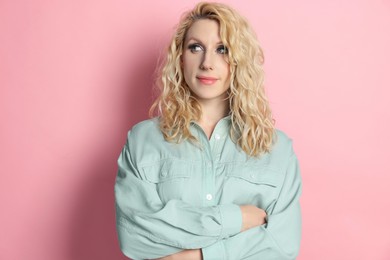 Portrait of beautiful young woman on pink background