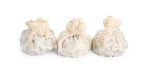 Photo of Three tasty khinkali (dumplings) and spices isolated on white. Georgian cuisine