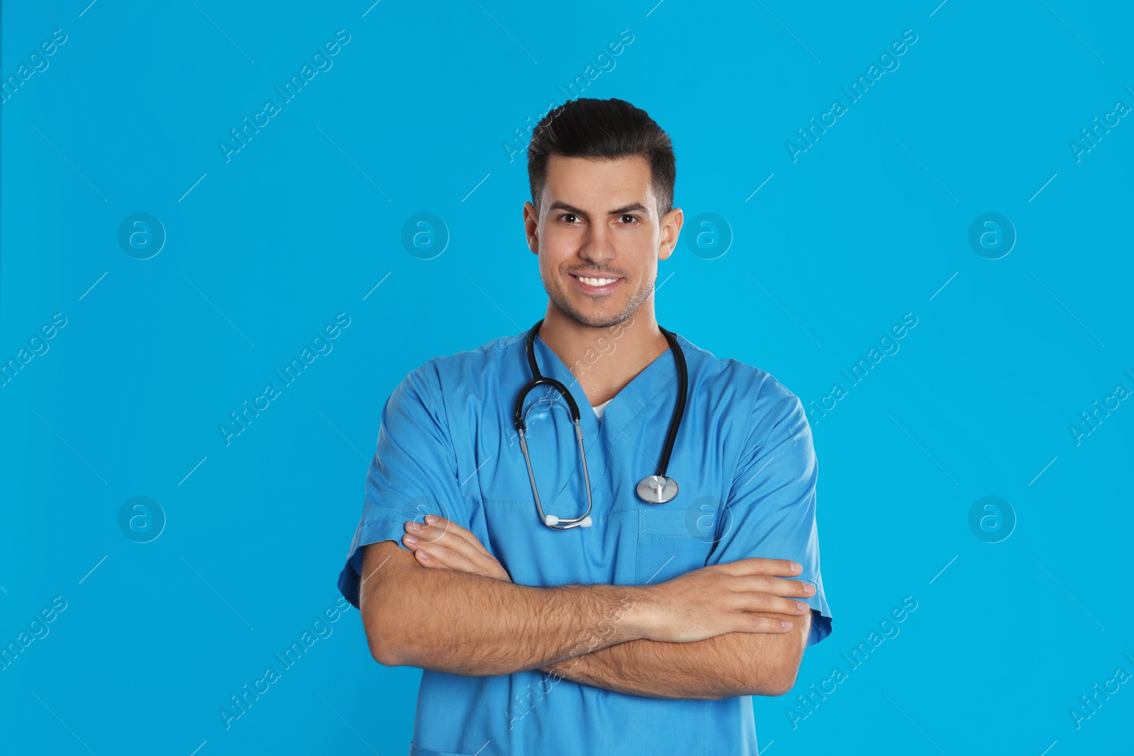 Photo of Portrait of doctor with stethoscope on blue background