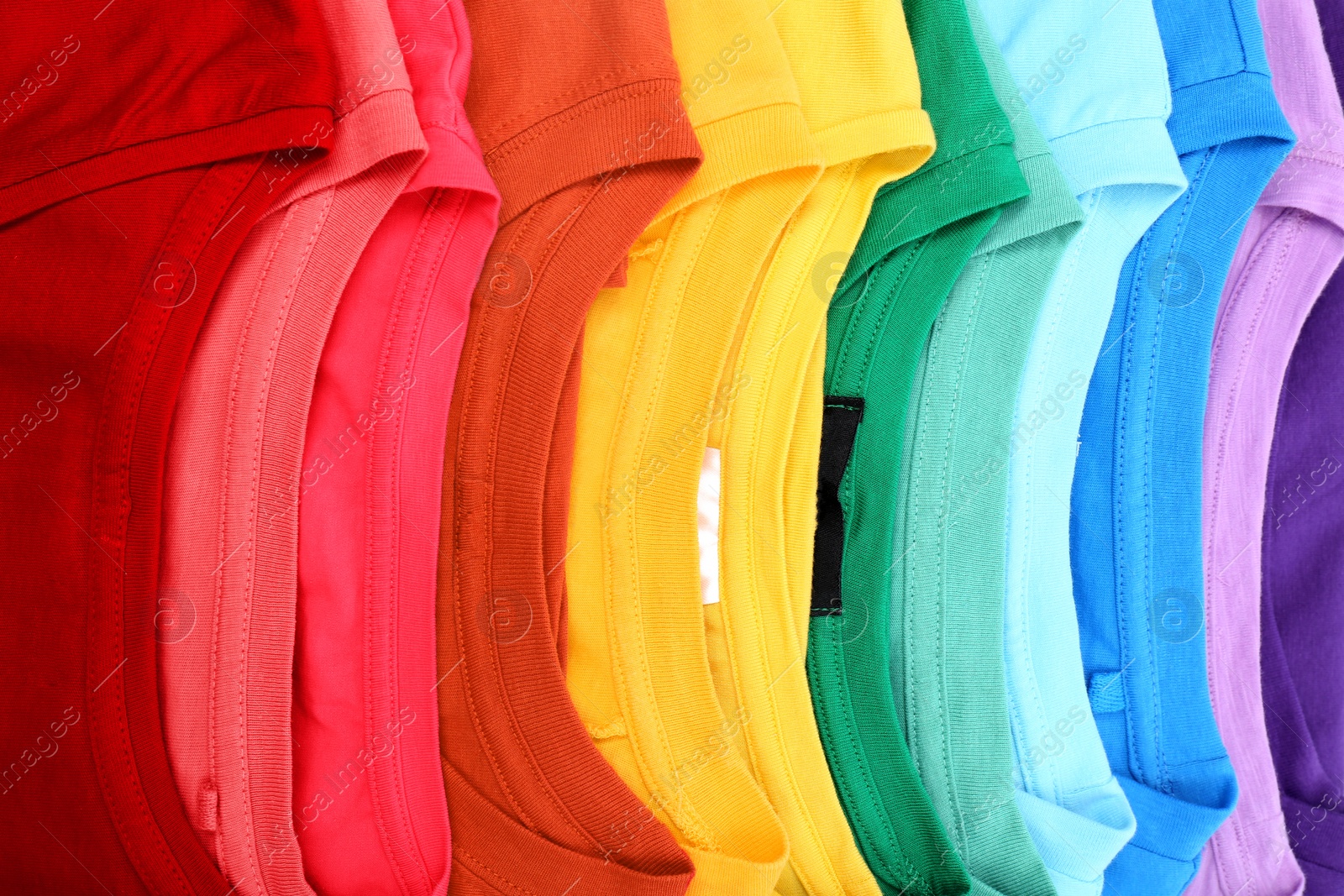 Photo of Many trendy colorful t-shirts, close up view