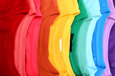 Photo of Many trendy colorful t-shirts, close up view