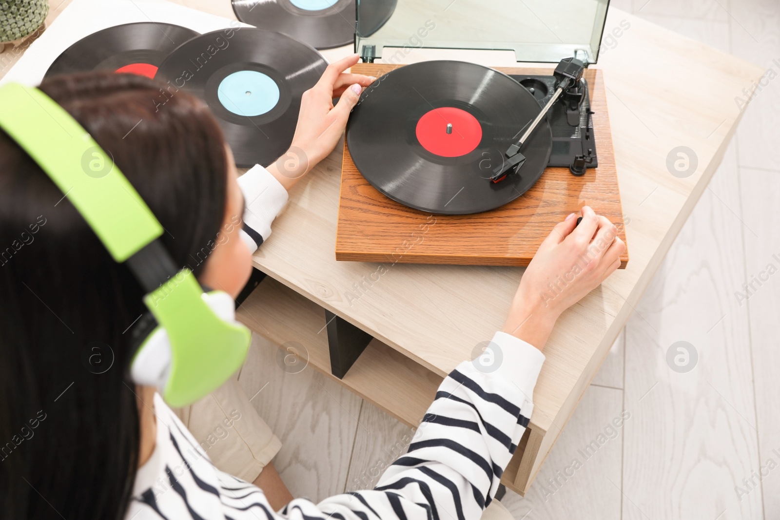 Photo of Woman listening to music with turntable at home, above view