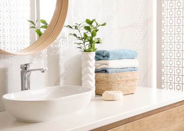 Photo of Stylish bathroom interior with mirror and countertop. Design idea