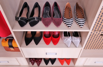 Photo of Wardrobe shelves with different stylish shoes