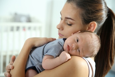 Young woman with her newborn baby at home