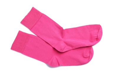 Photo of Pair of pink socks on white background, top view