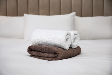 Photo of Soft clean terry towels on white bed
