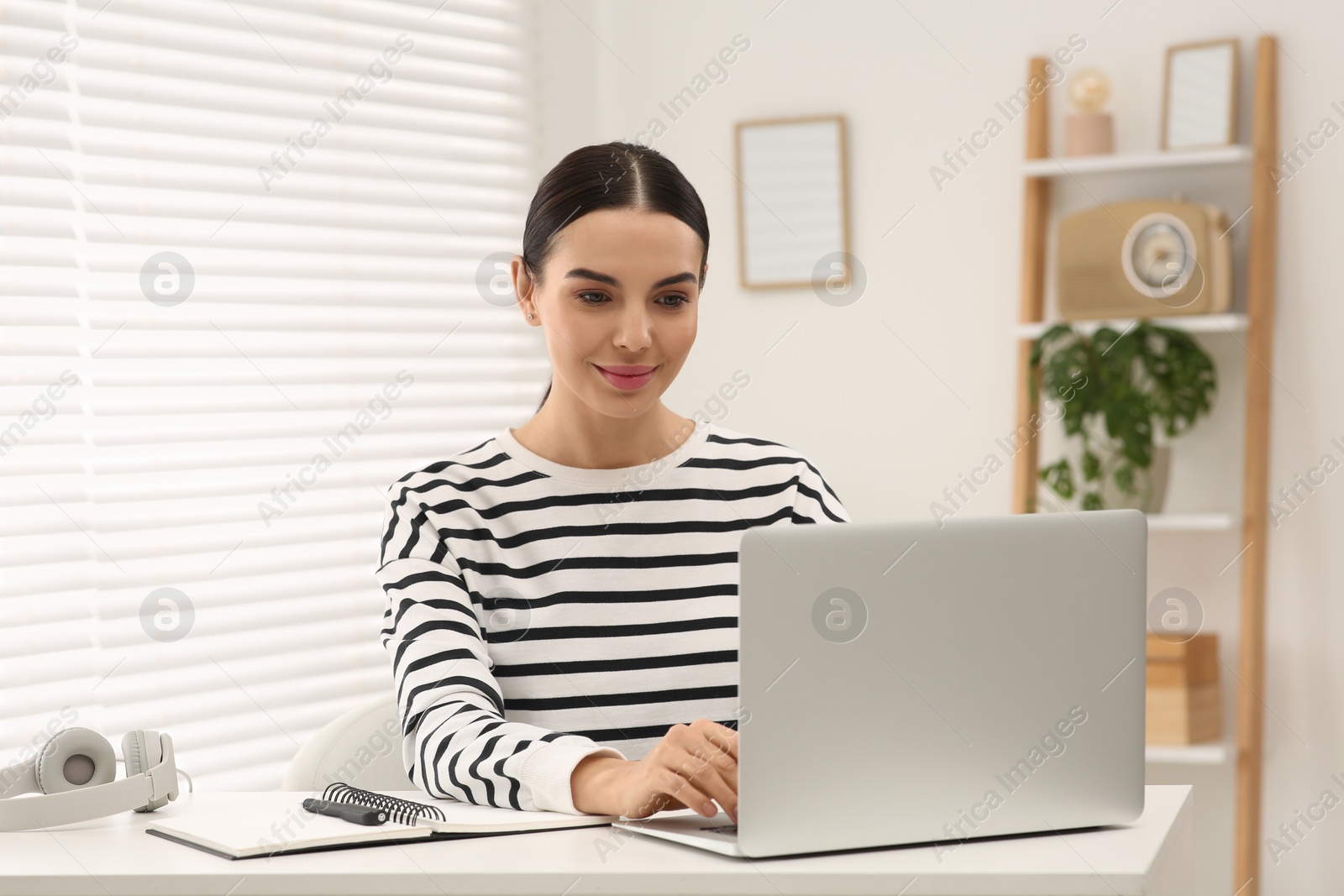 Photo of Online translation course. Student typing on laptop at home