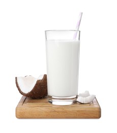Photo of Glass of delicious vegan milk near coconut pieces on white background