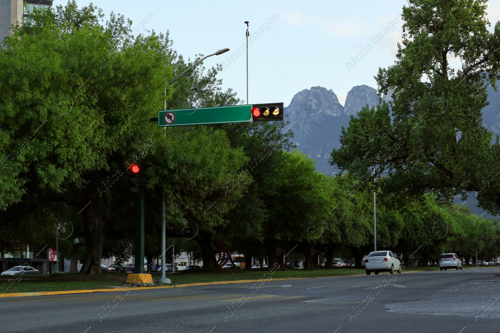 Photo of Red traffic lights and cars on road of city street