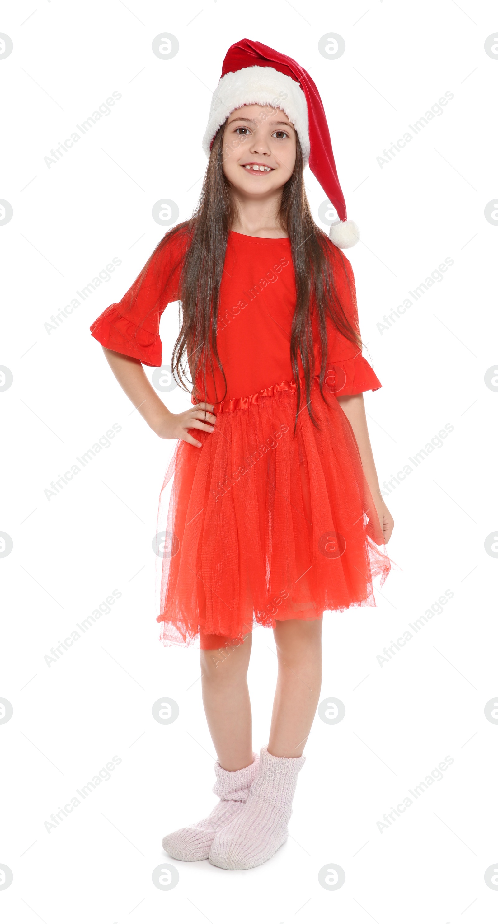 Photo of Cute little child in Santa hat posing on white background. Christmas celebration