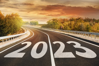 Image of Start new year with fresh vision and ideas. 2023 numbers on asphalt road