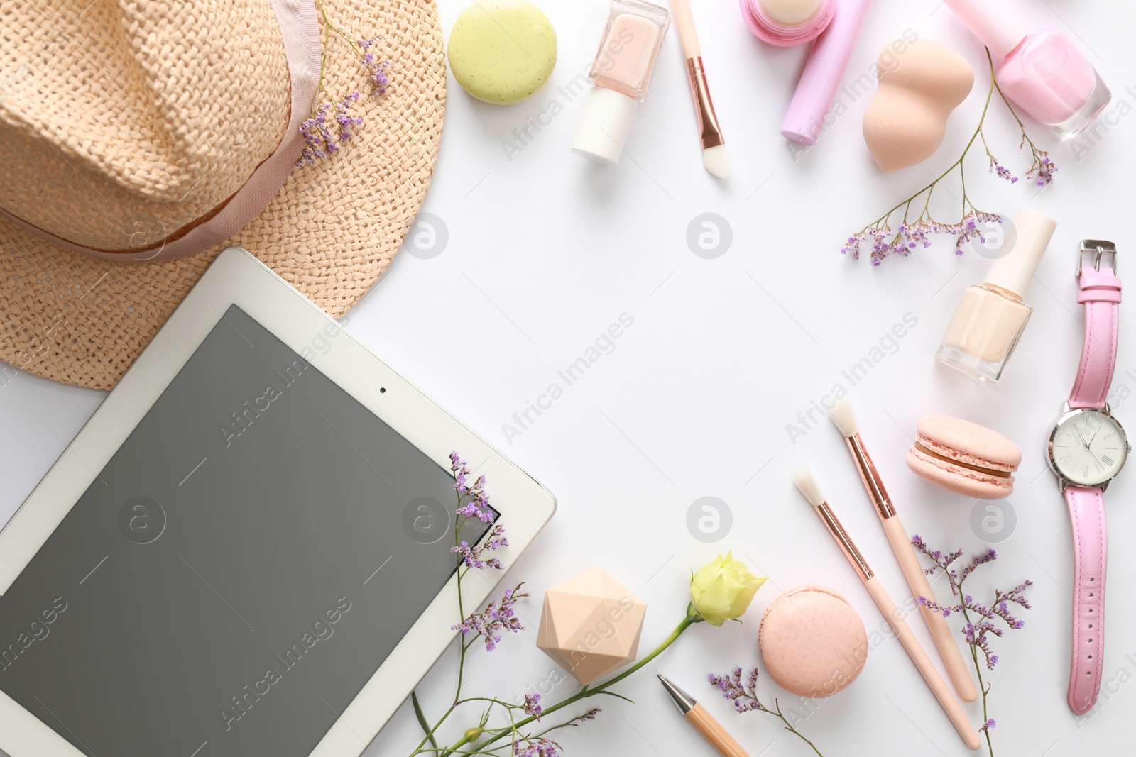 Photo of Frame made with tablet and beauty blogger's accessories on white background, top view