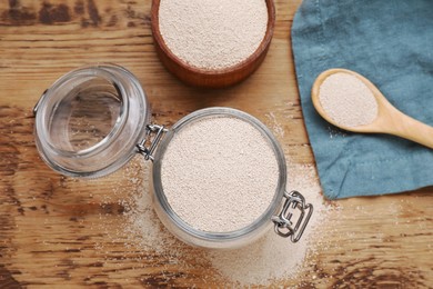Active dry yeast on wooden table, flat lay