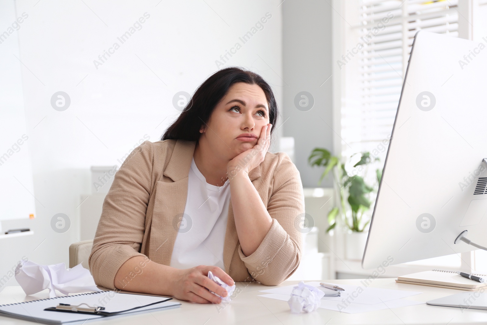 Photo of Lazy overweight worker at white desk in office