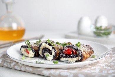 Photo of Delicious baked eggplant rolls served on white table