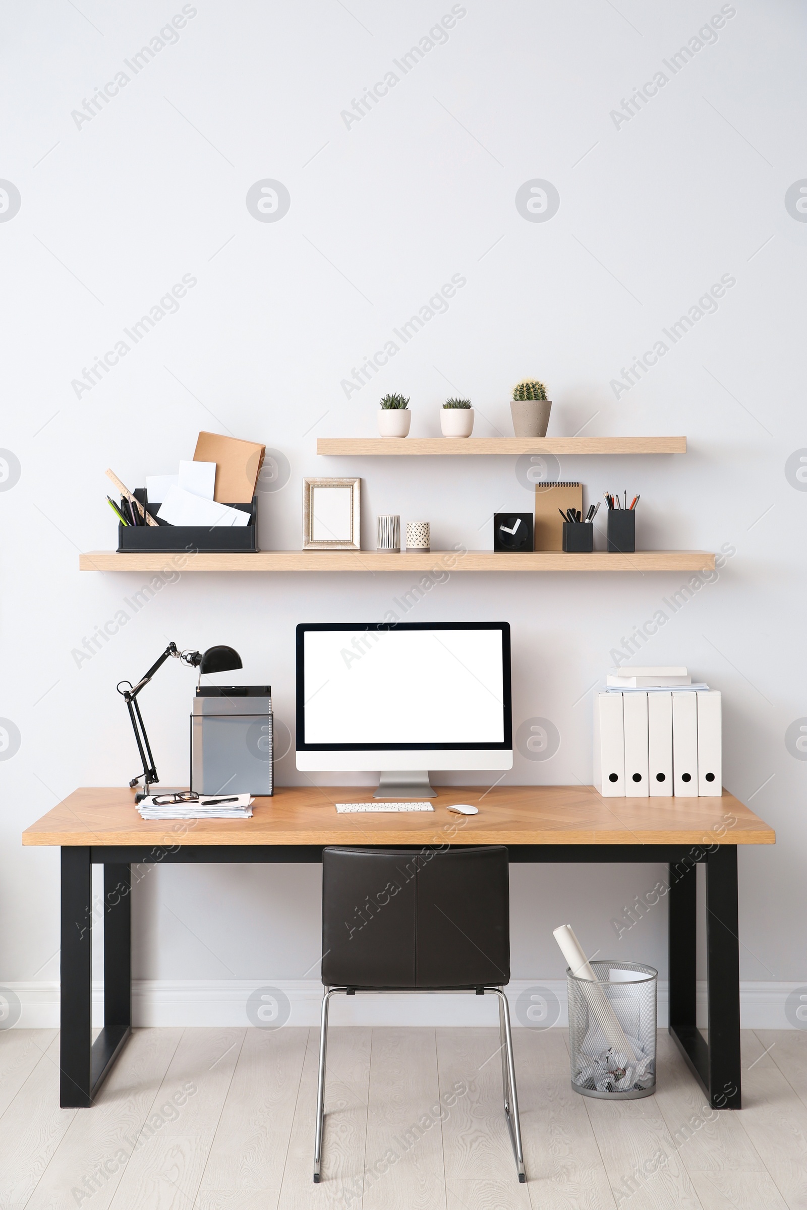 Photo of Modern computer on table in office interior. Stylish workplace