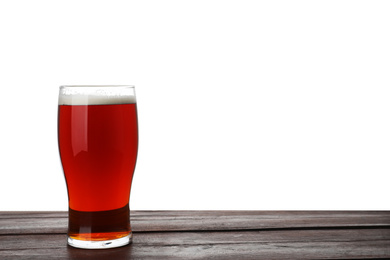 Glass of delicious kvass on wooden table, white background