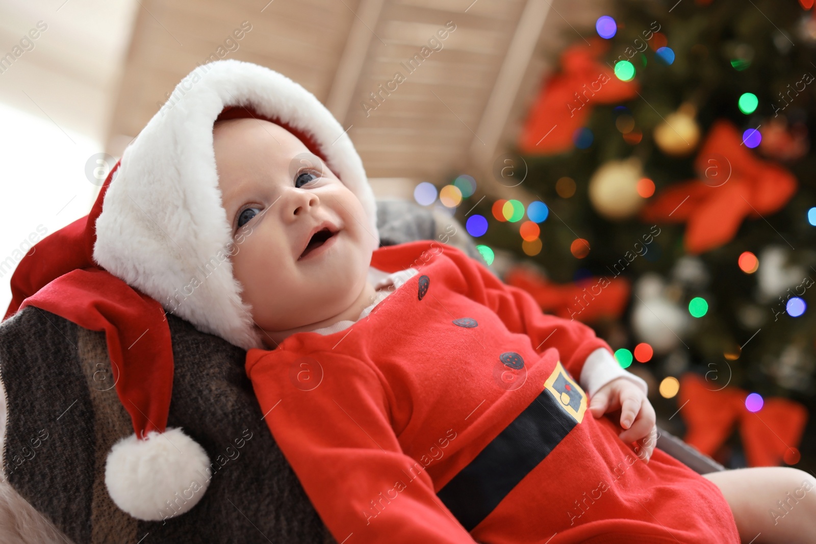 Photo of Cute baby in Christmas costume at home