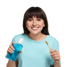 Young woman with mouthwash and toothbrush on white background