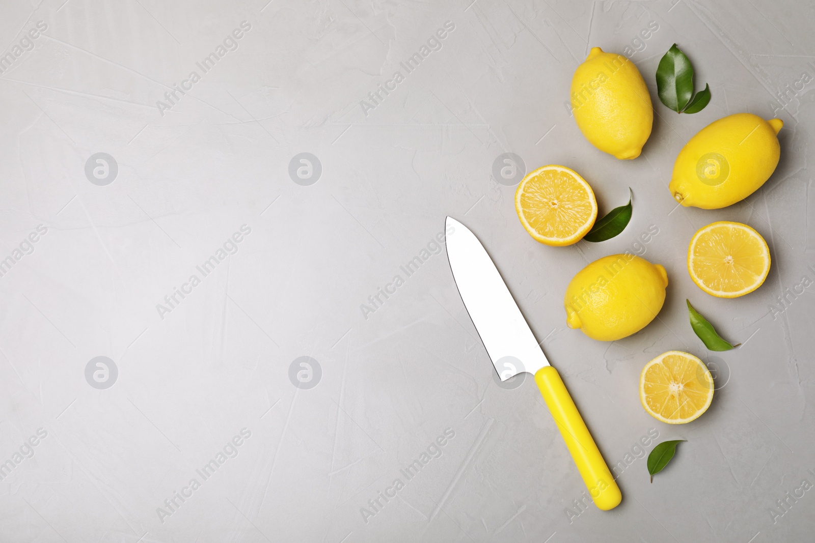 Photo of Flat lay composition with fresh lemons and space for text on table