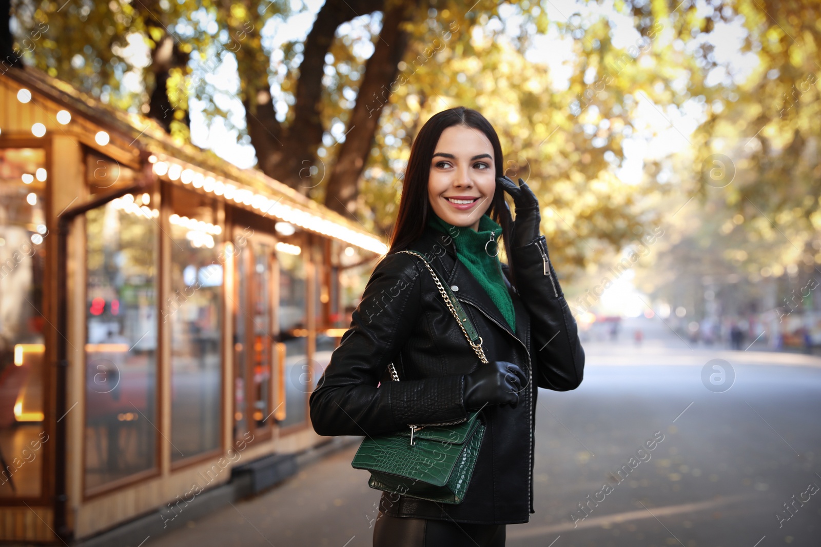 Photo of Portrait of beautiful young woman on city street. Autumn walk