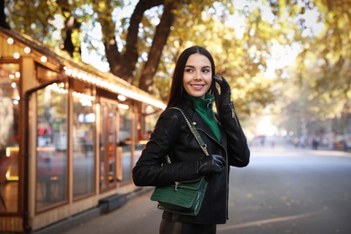Photo of Portrait of beautiful young woman on city street. Autumn walk